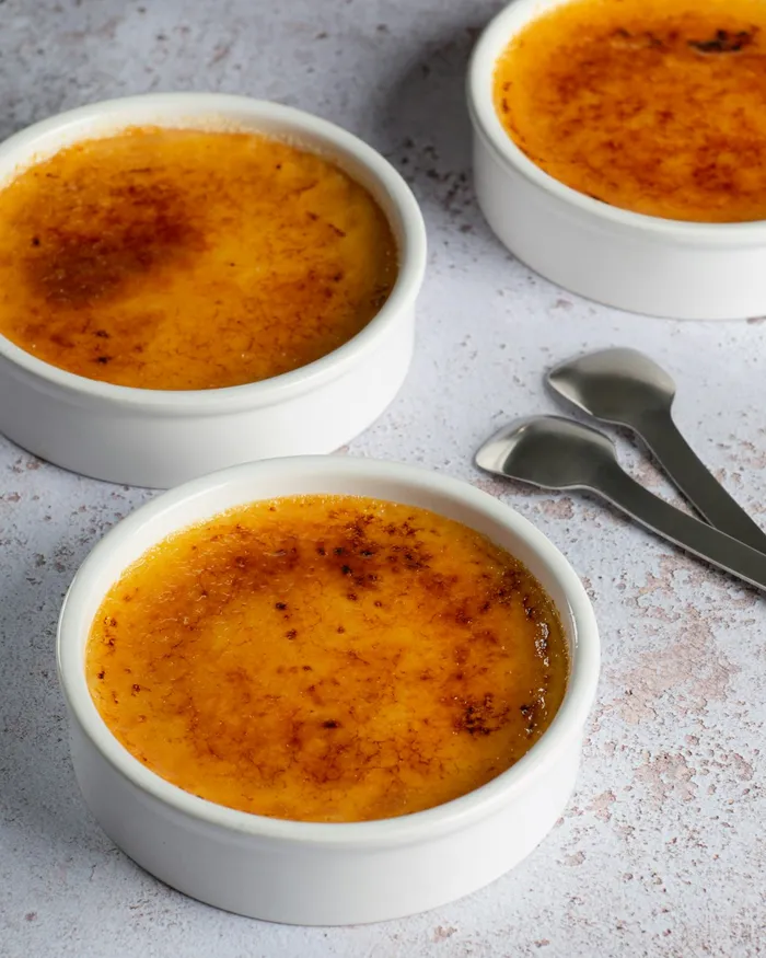 Slice of creme brulee cheesecake with crackly sugar crust