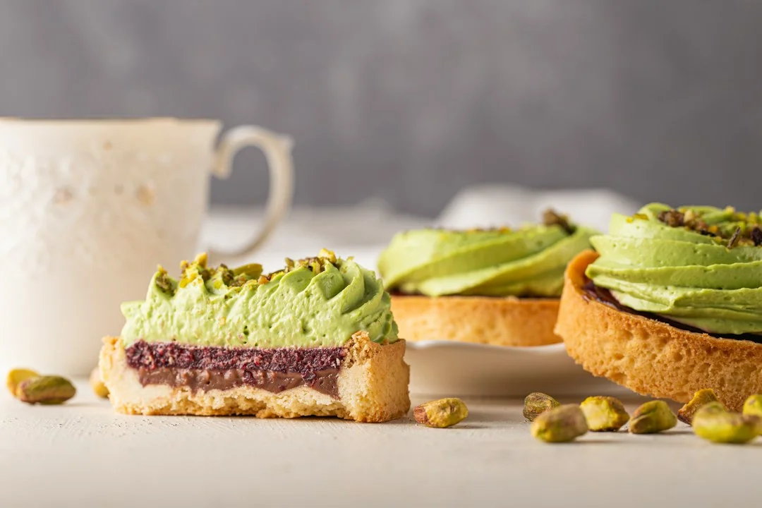 Pouring creamy pistachio cheesecake batter into springform pan